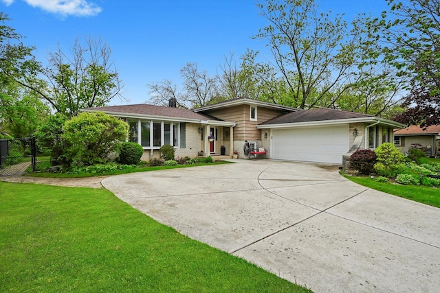 7513 Rohrer Dr, Downers Grove, IL 60516 - tri-level home with fence, an attached garage, brick siding, concrete driveway, and a front lawn