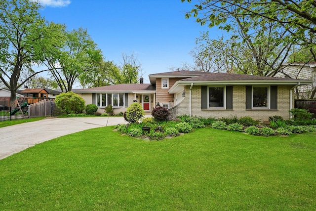 7513 Rohrer Dr, Downers Grove, IL 60516 - split level home featuring a front yard, brick siding, and fence