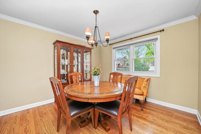 7513 Rohrer Dr, Downers Grove, IL 60516 - dining area with light wood-type flooring, baseboards, ornamental molding, and a notable chandelier