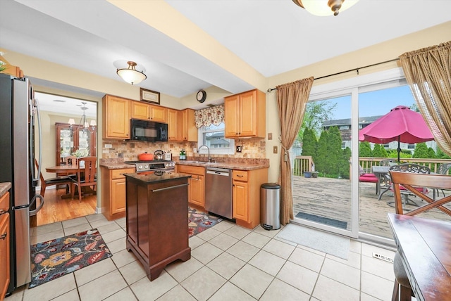 7513 Rohrer Dr, Downers Grove, IL 60516 - kitchen with a sink, decorative backsplash, a center island, light tile patterned floors, and appliances with stainless steel finishes