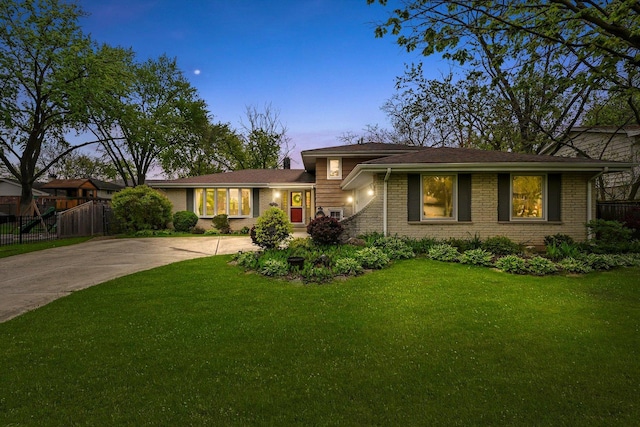 7513 Rohrer Dr, Downers Grove, IL 60516 - view of front of house with fence, concrete driveway, brick siding, and a front yard