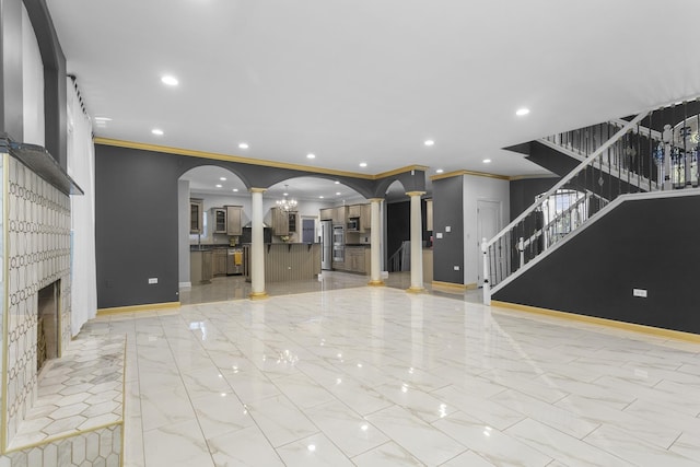 440 Delaware Cir, Bolingbrook, IL 60440 - unfurnished living room featuring stairway, ornate columns, recessed lighting, arched walkways, and ornamental molding