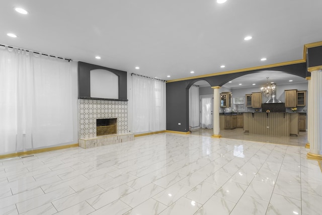 440 Delaware Cir, Bolingbrook, IL 60440 - unfurnished living room with a chandelier, light marble finish floors, decorative columns, a brick fireplace, and recessed lighting