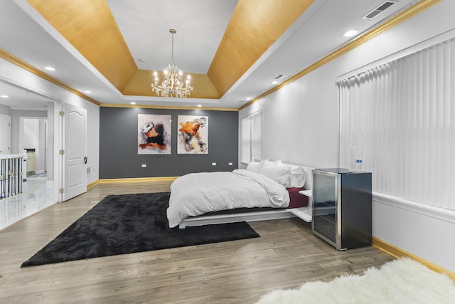 440 Delaware Cir, Bolingbrook, IL 60440 - bedroom with a tray ceiling, crown molding, a chandelier, wood finished floors, and recessed lighting