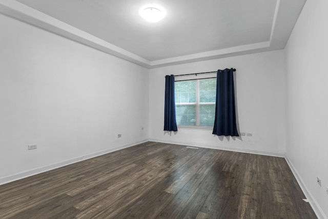 440 Delaware Cir, Bolingbrook, IL 60440 - unfurnished room featuring a tray ceiling and dark wood-style flooring