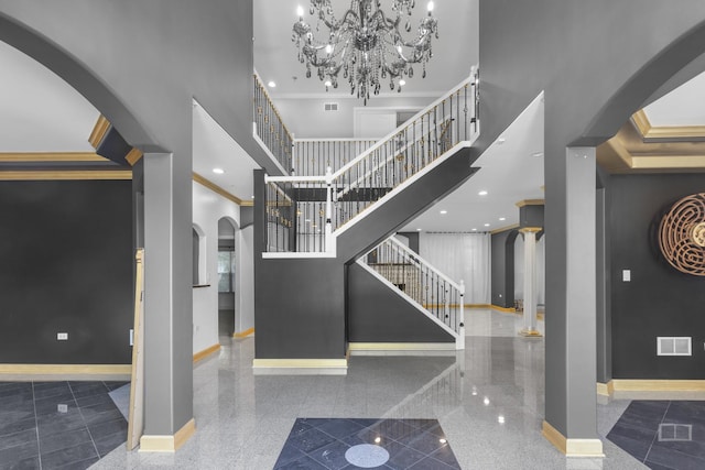 440 Delaware Cir, Bolingbrook, IL 60440 - staircase with arched walkways, a towering ceiling, granite tiled floors, ornamental molding, and a chandelier