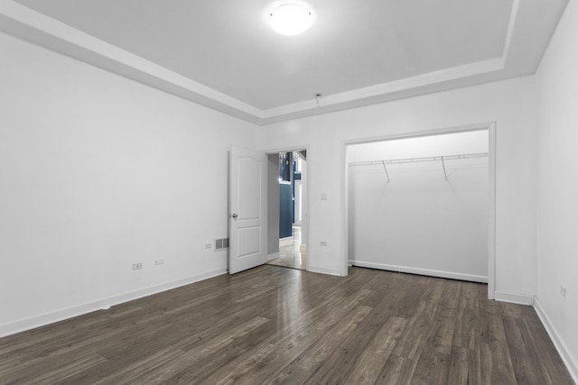 440 Delaware Cir, Bolingbrook, IL 60440 - unfurnished bedroom with a raised ceiling, a closet, and dark wood-style flooring