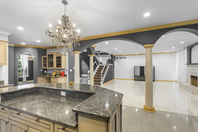 440 Delaware Cir, Bolingbrook, IL 60440 - kitchen featuring arched walkways, decorative columns, open floor plan, a chandelier, and ornamental molding
