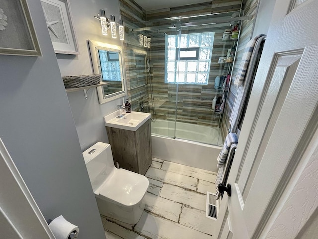 443 Indianwood Dr, Carol Stream, IL 60188 - bathroom featuring combined bath / shower with glass door, toilet, marble finish floors, and vanity