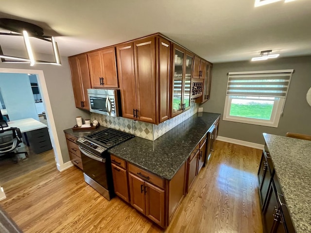 443 Indianwood Dr, Carol Stream, IL 60188 - kitchen featuring appliances with stainless steel finishes, light wood-style flooring, and brown cabinets