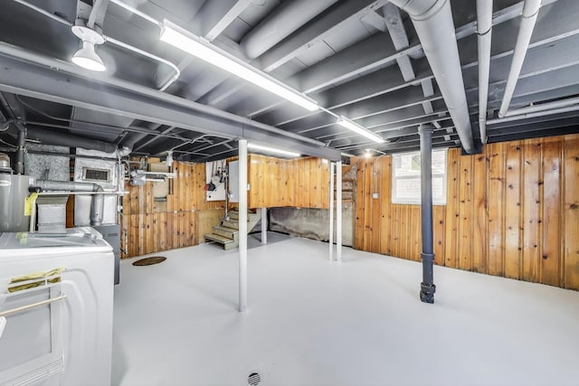 basement with washer / dryer, wooden walls, stairway, and gas water heater