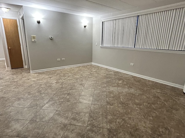 spare room with baseboards