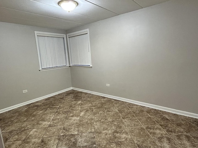 spare room featuring baseboards