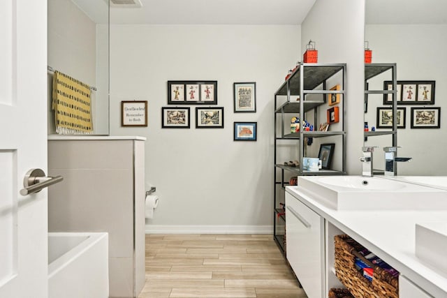 3940 N Ashland Ave Unit 2N, Chicago, IL 60613 - full bathroom featuring wood finished floors, baseboards, and double vanity