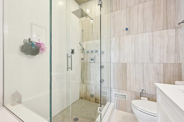 3940 N Ashland Ave Unit 2N, Chicago, IL 60613 - full bathroom featuring a stall shower, toilet, vanity, and tile walls