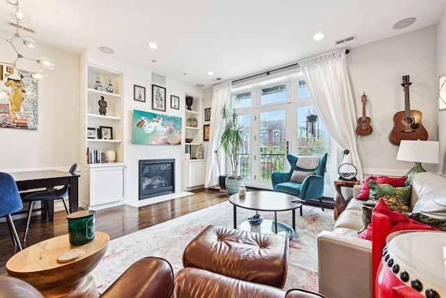 3940 N Ashland Ave Unit 2N, Chicago, IL 60613 - living area featuring wood finished floors, recessed lighting, built in features, a fireplace with flush hearth, and baseboards