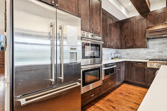 3940 N Ashland Ave Unit 2N, Chicago, IL 60613 - kitchen featuring appliances with stainless steel finishes, dark brown cabinets, wood finished floors, and light countertops