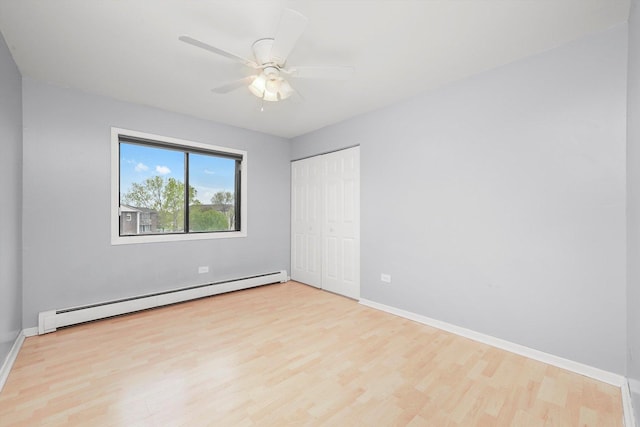 9960 Franchesca Ct Unit 3A, Orland Park, IL 60462 - unfurnished bedroom featuring a closet, wood finished floors, baseboards, and a baseboard heating unit