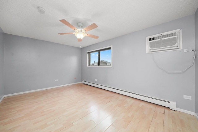 9960 Franchesca Ct Unit 3A, Orland Park, IL 60462 - spare room featuring a baseboard radiator, an AC wall unit, a ceiling fan, and light wood-style floors
