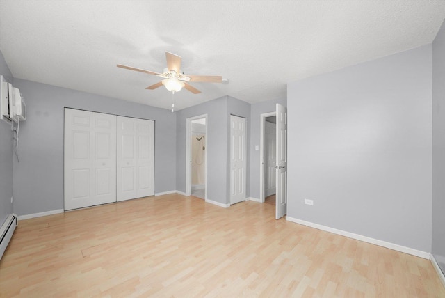 9960 Franchesca Ct Unit 3A, Orland Park, IL 60462 - unfurnished bedroom featuring a ceiling fan, baseboard heating, baseboards, light wood finished floors, and multiple closets