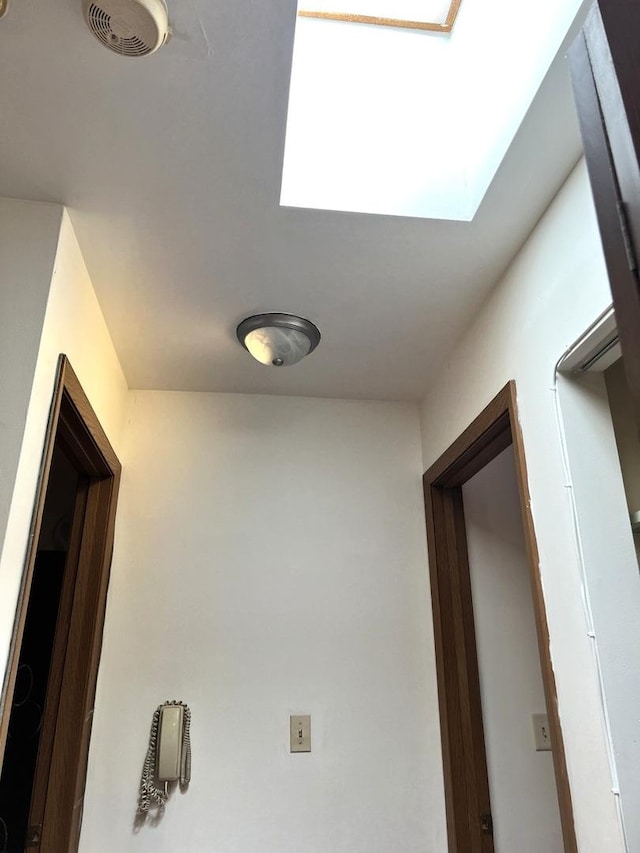 hallway featuring a skylight