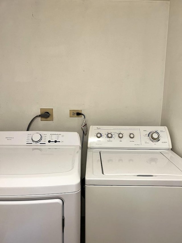 clothes washing area with washer and clothes dryer