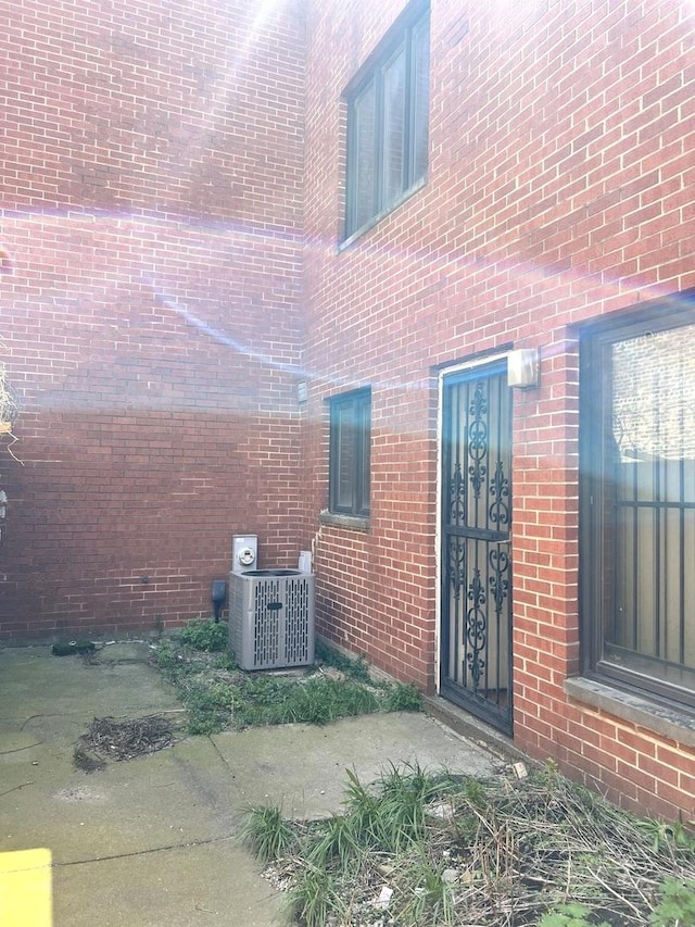 view of home's exterior featuring central AC and brick siding