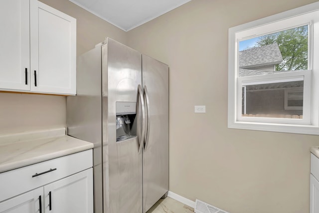 622 E Joliet St, Ottawa, IL 61350 - kitchen featuring stainless steel refrigerator with ice dispenser, white cabinets, crown molding, and baseboards