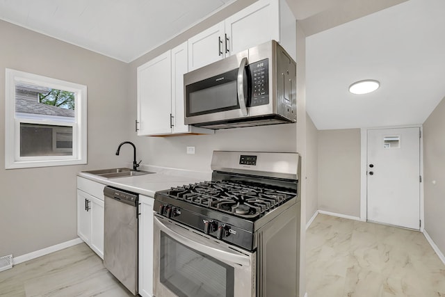 622 E Joliet St, Ottawa, IL 61350 - kitchen with appliances with stainless steel finishes, a sink, light marble finish flooring, baseboards, and white cabinetry