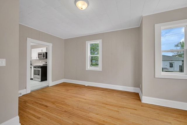 622 E Joliet St, Ottawa, IL 61350 - empty room featuring crown molding, light wood-type flooring, and baseboards