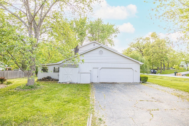 view of property exterior featuring a garage and driveway