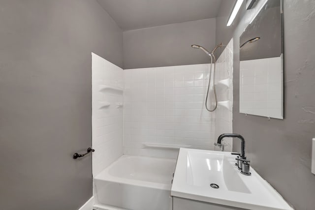 bathroom featuring washtub / shower combination and vanity
