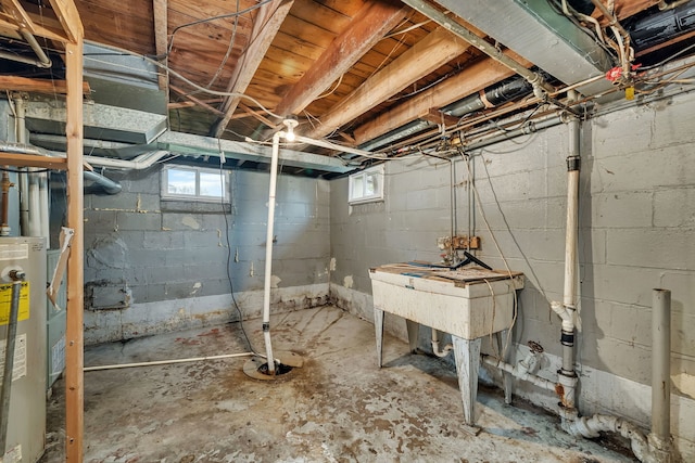 basement featuring a healthy amount of sunlight and gas water heater