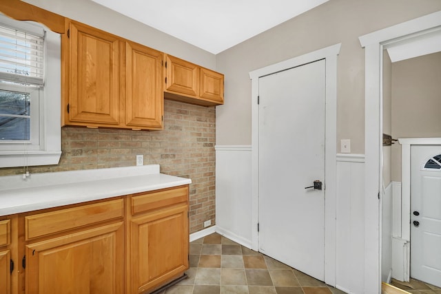 laundry room featuring a wainscoted wall