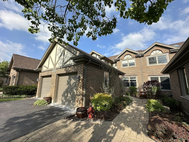 14609 Morningside Rd, Orland Park, IL 60462 - view of front of house with brick siding, asphalt driveway, an attached garage, and stucco siding
