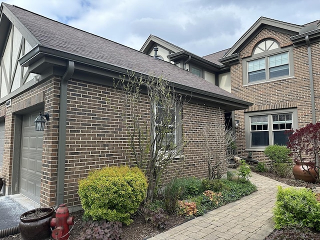 14609 Morningside Rd, Orland Park, IL 60462 - view of home's exterior featuring brick siding, roof with shingles, and a garage