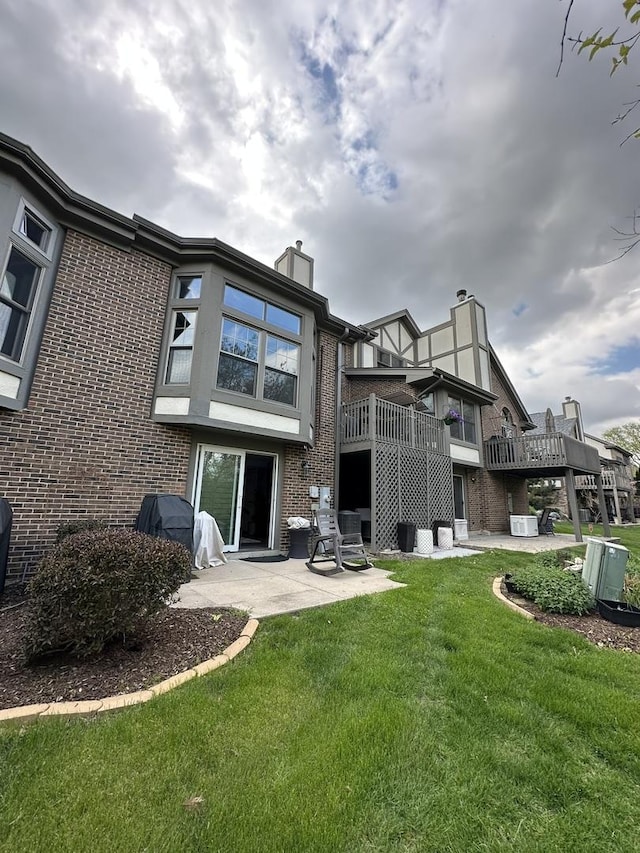 14609 Morningside Rd, Orland Park, IL 60462 - rear view of house featuring brick siding, a patio area, a lawn, and a chimney