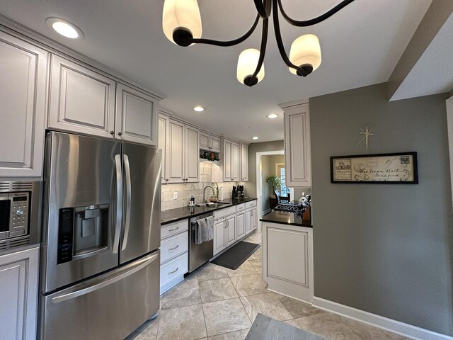 14609 Morningside Rd, Orland Park, IL 60462 - kitchen featuring stainless steel appliances, dark countertops, tasteful backsplash, a sink, and recessed lighting