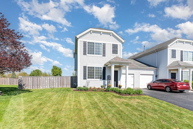 traditional home featuring an attached garage and asphalt driveway