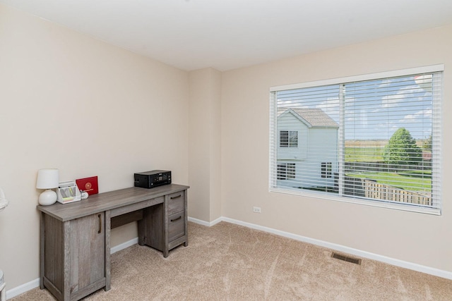 home office featuring light carpet and baseboards