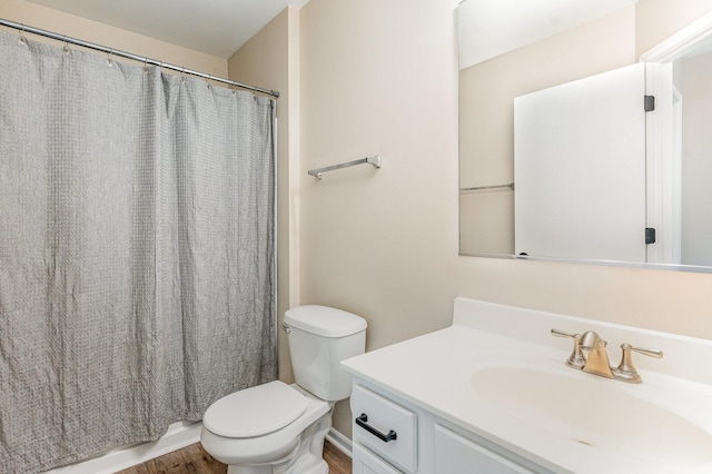 full bathroom featuring toilet, vanity, wood finished floors, and curtained shower