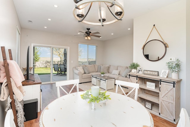 dining space featuring light wood-style floors, a chandelier, recessed lighting, and a ceiling fan