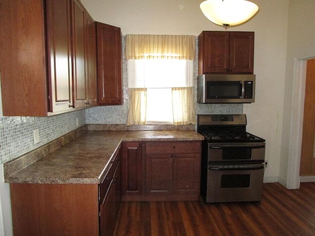 8742 S Racine Ave, Chicago, IL 60620 - kitchen with stainless steel appliances, dark wood-type flooring, decorative backsplash, baseboards, and dark countertops