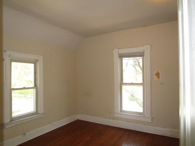 8742 S Racine Ave, Chicago, IL 60620 - empty room featuring dark wood-type flooring, healthy amount of natural light, lofted ceiling, and baseboards