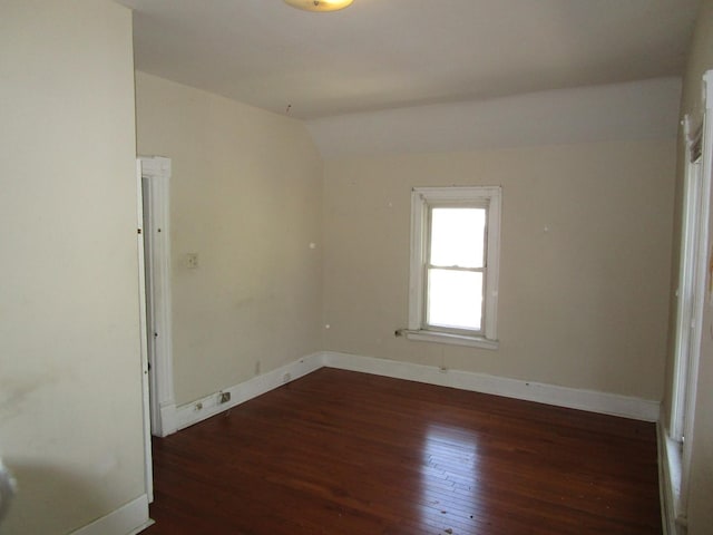 8742 S Racine Ave, Chicago, IL 60620 - empty room featuring wood-type flooring, lofted ceiling, and baseboards