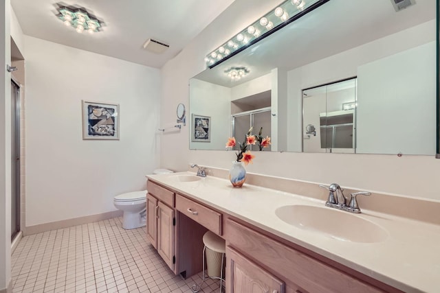 full bath featuring baseboards, a shower stall, toilet, double vanity, and tile patterned flooring