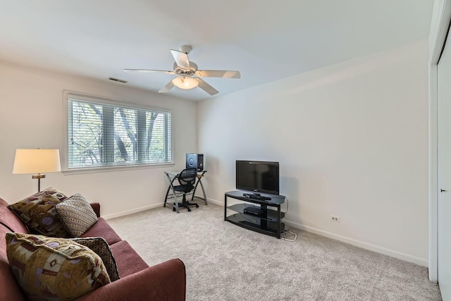 living area with carpet floors, ceiling fan, and baseboards