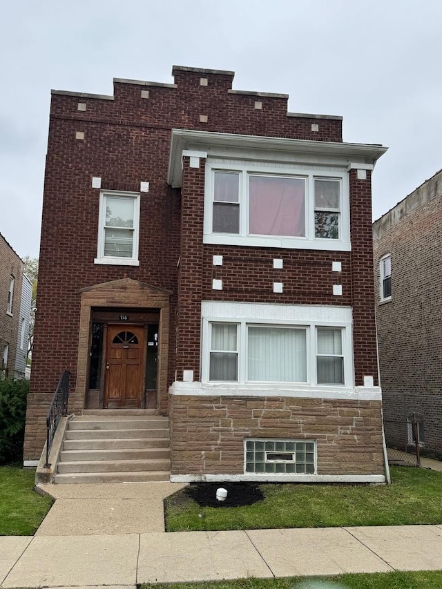 view of front of house featuring stone siding and brick siding