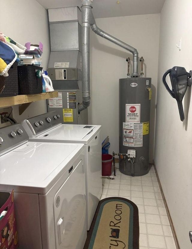 laundry area with light floors, baseboards, gas water heater, washer and clothes dryer, and laundry area