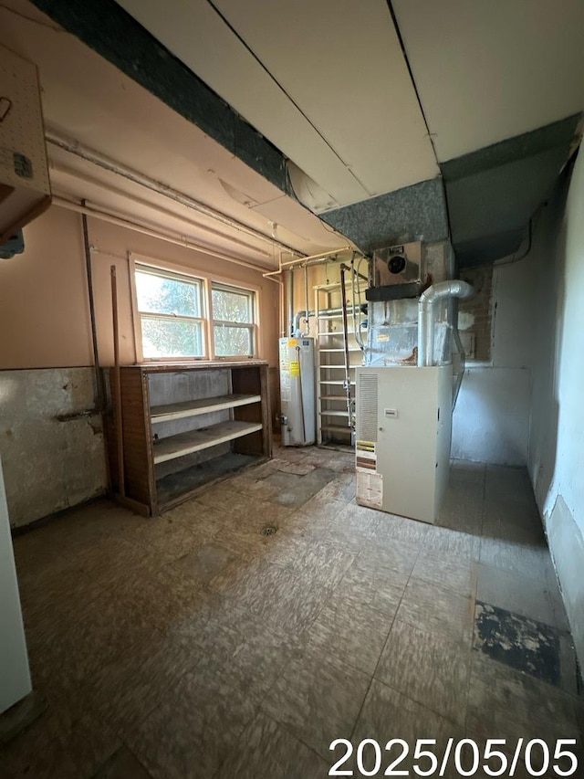basement featuring gas water heater and heating unit